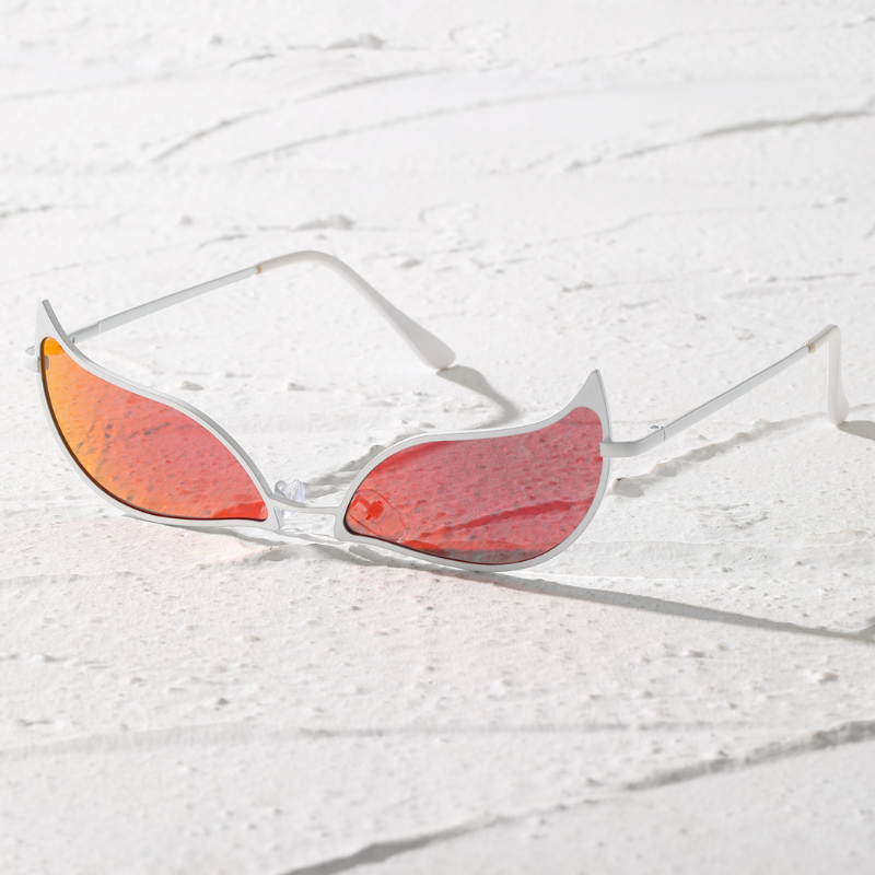 White-framed, futuristic sunglasses with red, iridescent, wing-shaped lenses and a lightweight frame offer UV400 protection, resting on a textured white surface.
