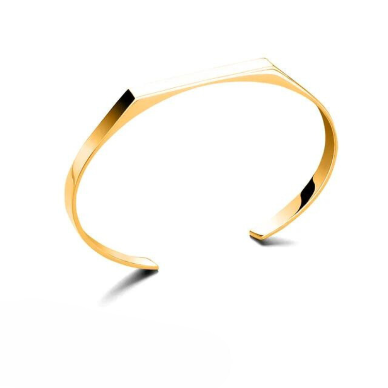 A minimalist cuff with a sleek, angular design, this gold-colored bracelet features 18K gold plating and is displayed on a white background with a subtle shadow beneath it.