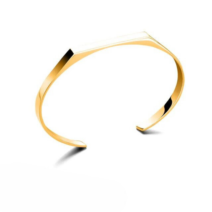 A minimalist cuff with a sleek, angular design, this gold-colored bracelet features 18K gold plating and is displayed on a white background with a subtle shadow beneath it.