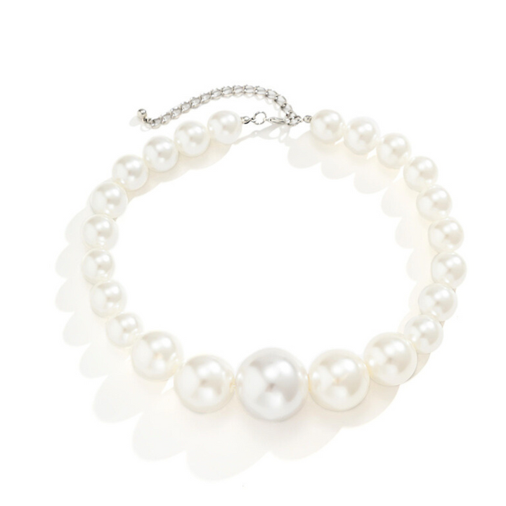 A statement jewelry piece, this pearl necklace features large, round white pearls with a larger central pearl and a silver adjustable chain clasp, making it a standout addition to any pearl jewelry set. Displayed on a white background.