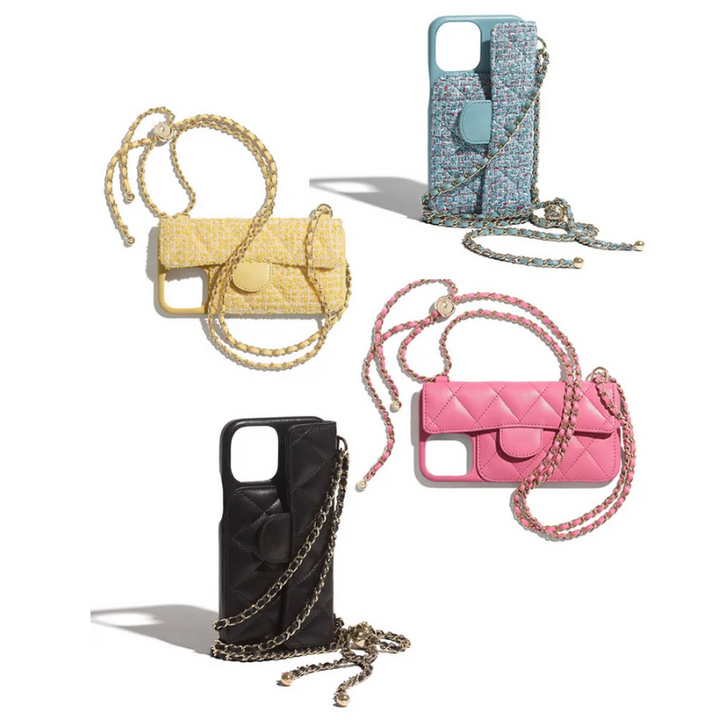 Four iPhone cases styled like mini purses with a stylish chain strap are arranged on a white background. The cases are yellow, blue patterned, black, and pink, each resembling a quilted or textured handbag.
