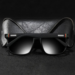 A pair of stylish UV400 sunglasses with gradient lenses rest in front of a black textured leather case, set against a dark background.