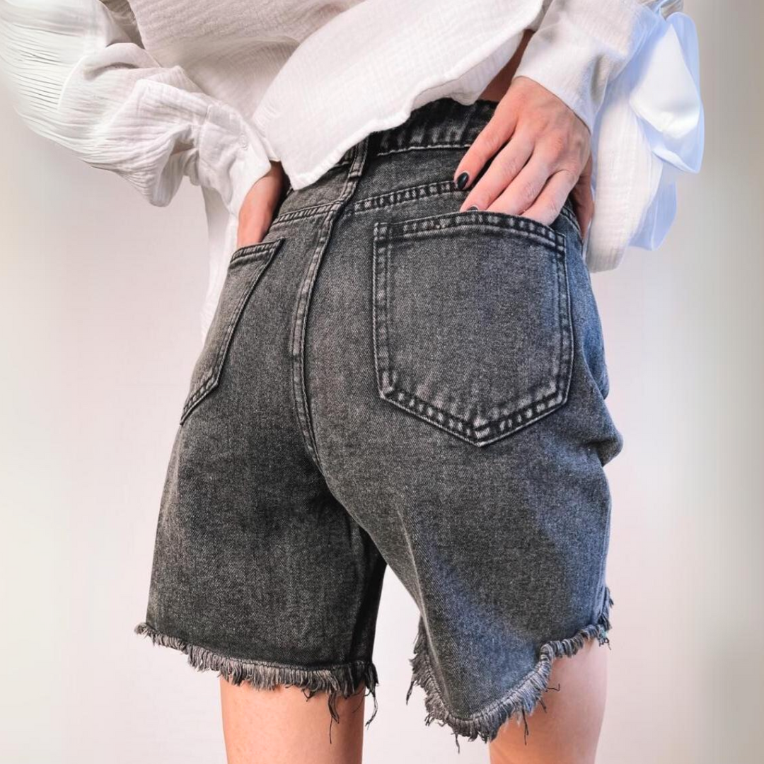 A person wearing high-waist denim shorts.