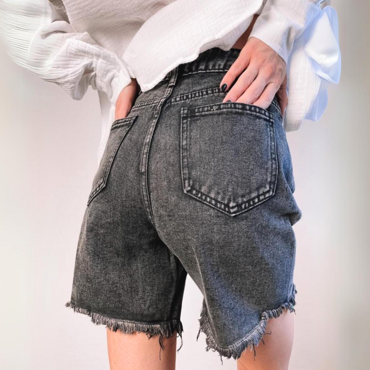 A person wearing high-waist denim shorts.