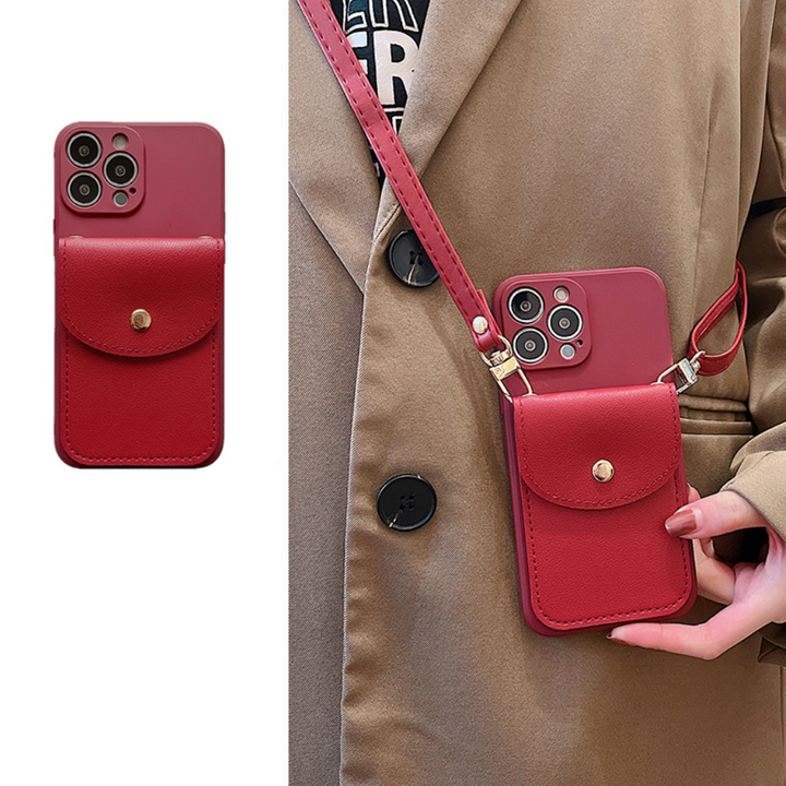 A person wearing a brown coat holds a red phone in a matching red phone case wallet with a snap button pocket. The close-up shows the secure cardholder and how its worn across the body with its leather detachable strap.