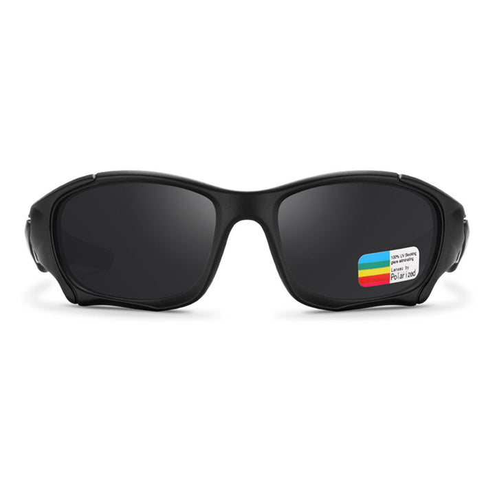 A pair of black wraparound sports sunglasses with dark lenses, shown from the front. A small rectangular sticker with colorful stripes and text is attached to one lens.