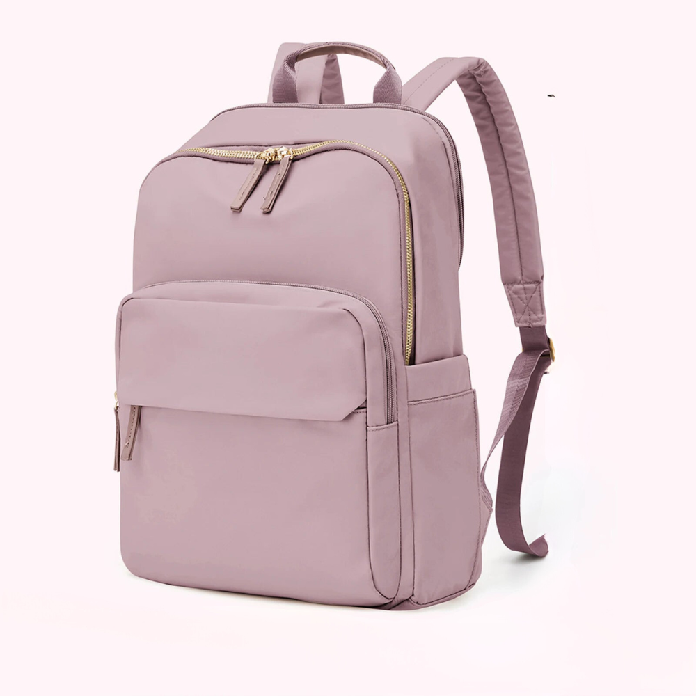 A lightweight, durable mauve backpack with gold zippers, multiple pockets, a laptop compartment, and adjustable shoulder straps, displayed against a plain light background.