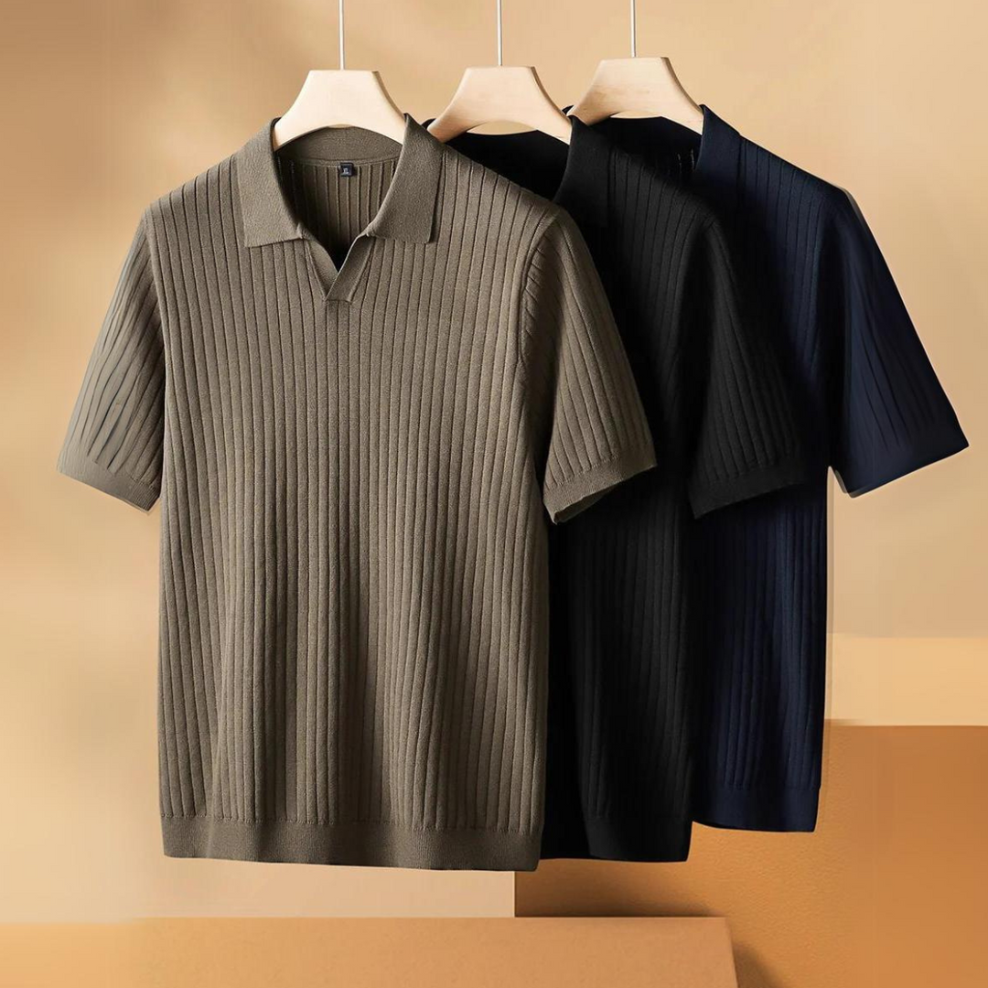 Three ribbed knit polo shirts in olive, black, and navy blue hang on wooden hangers against a neutral beige background—perfect lightweight polos for the urban professional.