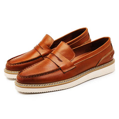 A pair of brown Italian leather penny loafers with white rubber soles and visible stitching, perfect for a business casual look, displayed on a white background.