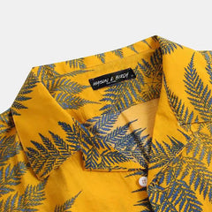 A yellow cotton shirt with a classic design, featuring blue fern leaf patterns. The brand label inside the collar reads MASON & BIRCH. The shirt is buttoned and displayed against a plain background—ideal for a casual brunch.
