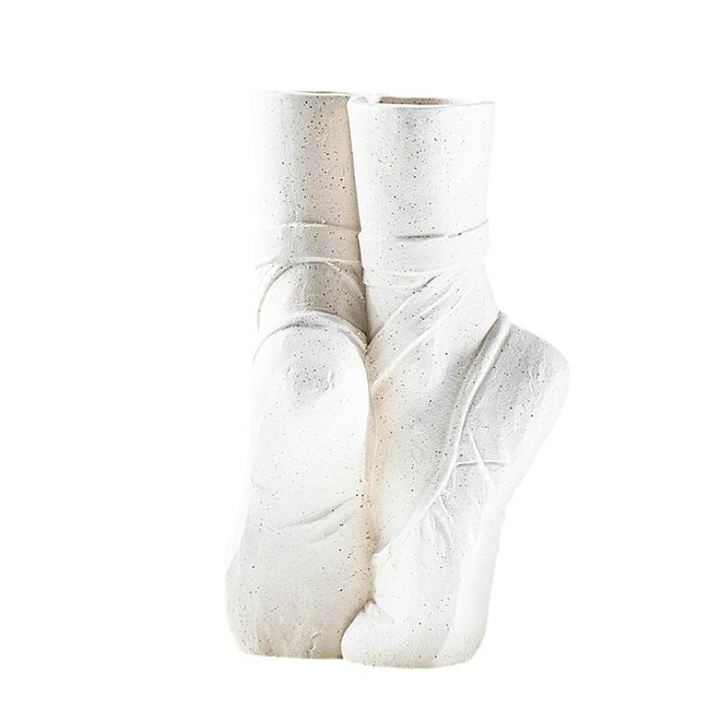 A ballet-inspired vase shaped like two ballet slippers standing upright, with detailed lines and satin-like textures—perfect for adding contemporary chic décor to any space.