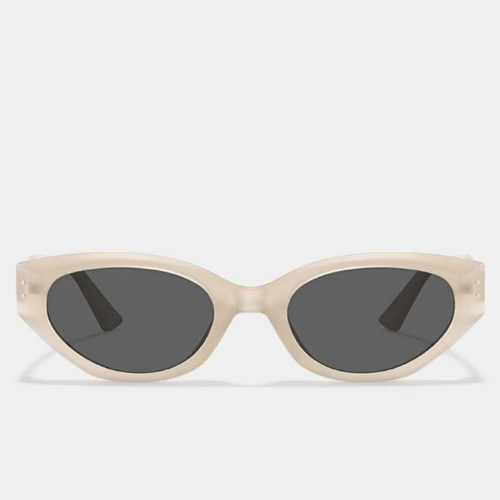 A pair of sunglasses with thick, cream-colored oval frames crafted from translucent acetate and dark UV400 protection lenses, displayed against a plain light background.