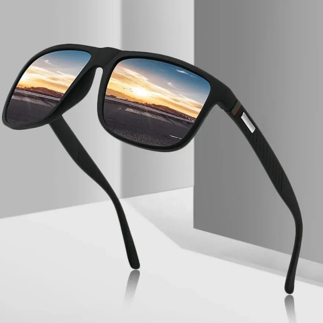 A pair of stylish sunglasses with reflective lenses showing a sunset scene, featuring a road and a colorful sky with clouds. These UV400 sunglasses are displayed on a white and gray surface with a minimalistic background.