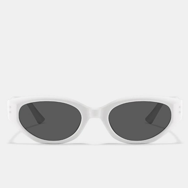 A pair of oval-shaped sunglasses with a translucent acetate frame and dark, scratch-resistant lenses, displayed against a plain light gray background.