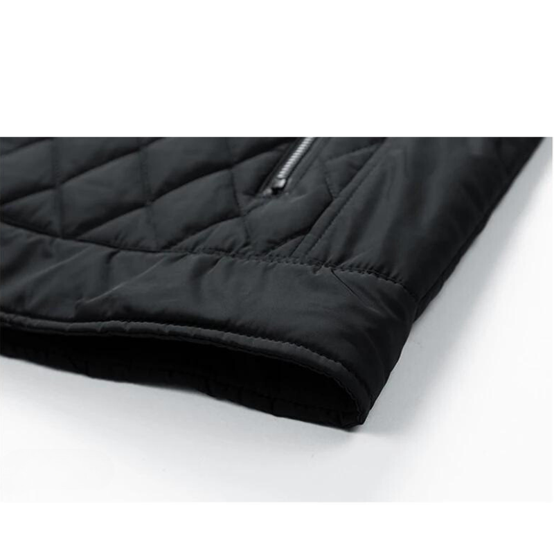 Close-up of the lower section of a black slim-fit jacket, showing stitching details, a segment of a zipper pocket, and the hem with a smooth finish for a wind-resistant finish.