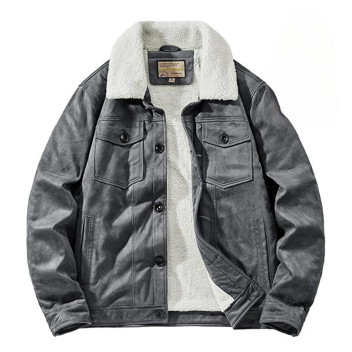 A gray suede jacket with a white, fluffy Sherpa lining and collar, front button closures, and two chest pockets with flaps. The jacket offers a structured fit and is laid flat on a white background.