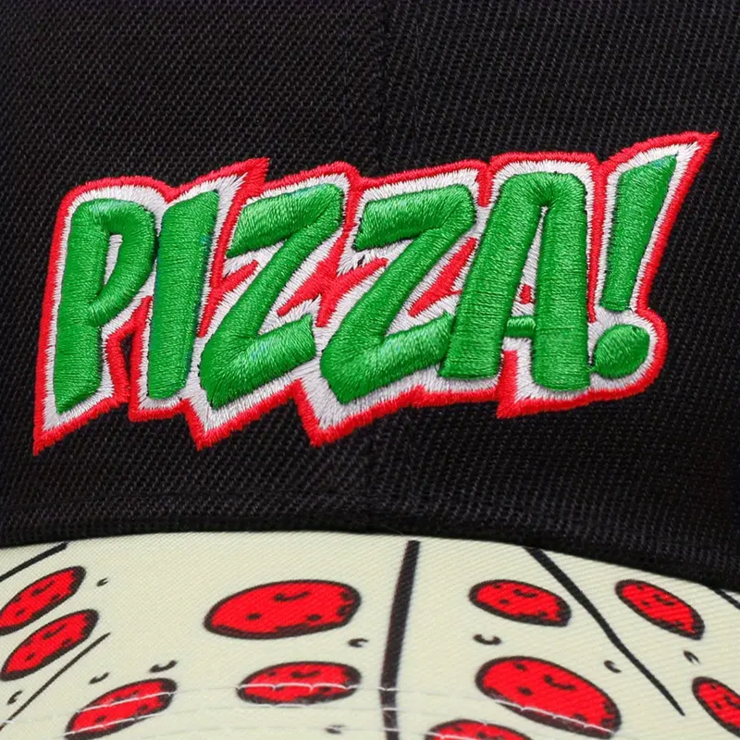 A statement piece, this black cap features PIZZA! embroidered in bold green letters outlined in red, and a unique brim hat design covered with cartoon pizza slices topped with gooey cheese and pepperoni.