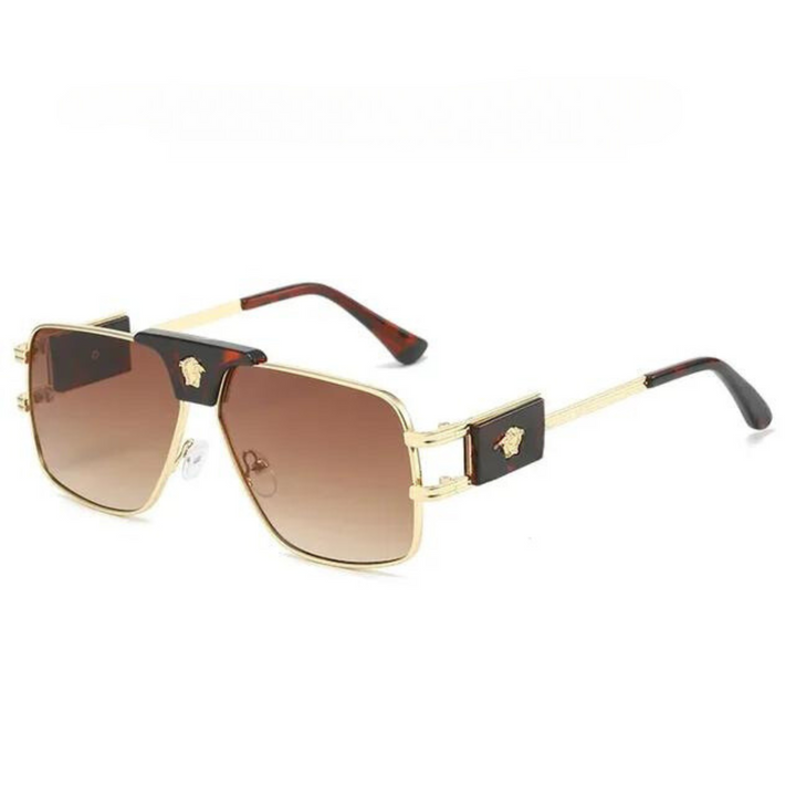 Gold-rimmed square bold sunglasses with brown gradient lenses, featuring premium metal frames and black and gold decorative accents on the temples. Stylish and modern, they offer UV400 protection for your eyes.