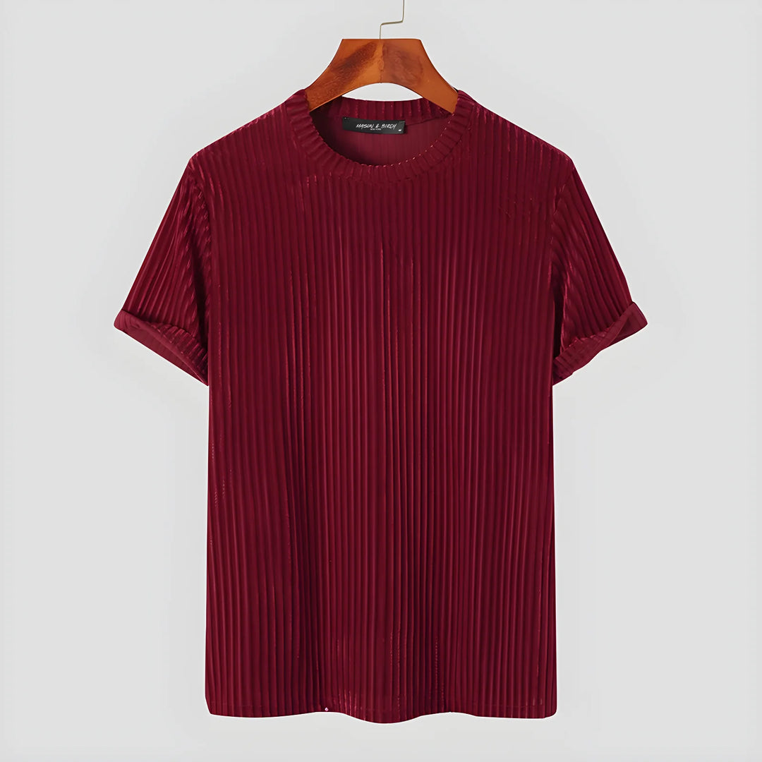 A short-sleeved, ribbed maroon T-shirt with rolled cuffs and classic fit is hanging on a wooden hanger against a plain white background.