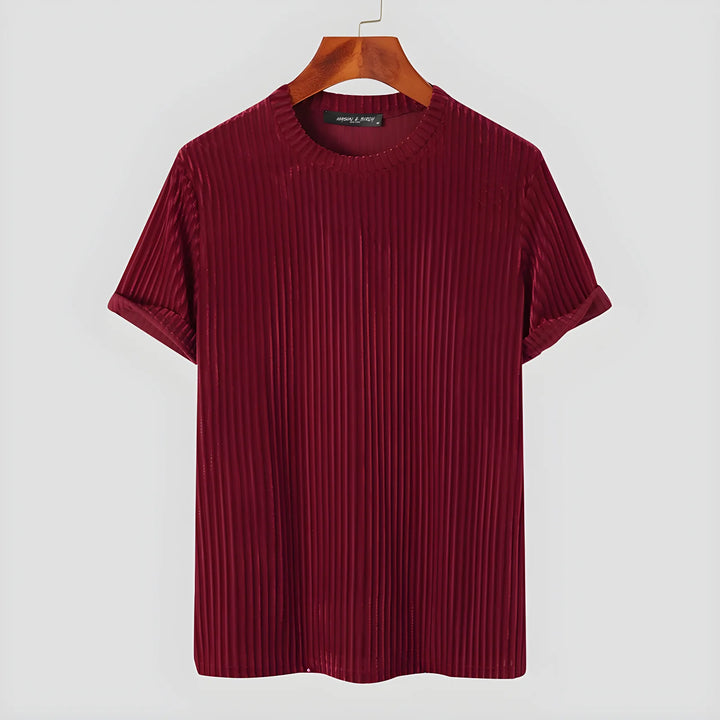 A short-sleeved, ribbed maroon T-shirt with rolled cuffs and classic fit is hanging on a wooden hanger against a plain white background.