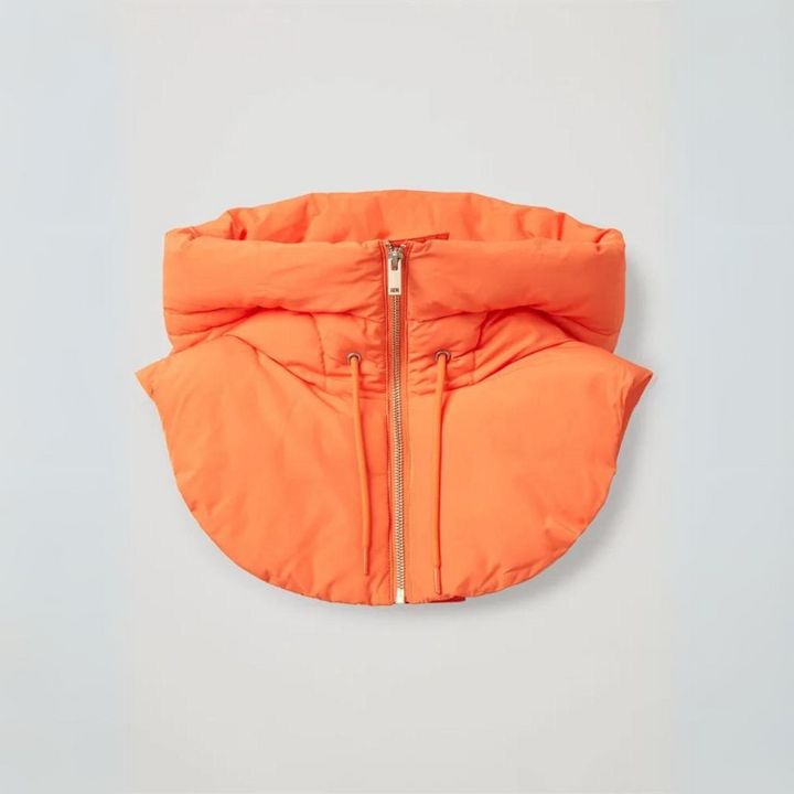 An orange, lightweight padded puffer scarf with a high collar and a central silver zipper, laid flat on a neutral background.