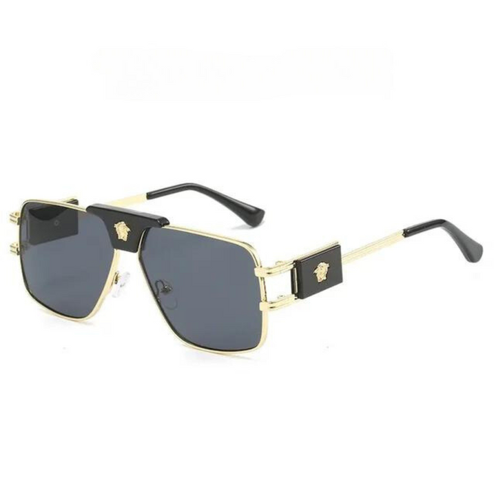 Black and gold square bold sunglasses with dark UV400 protection lenses, featuring a gold emblem on each side of the premium metal frames and thick arms with black tips, displayed on a white background.