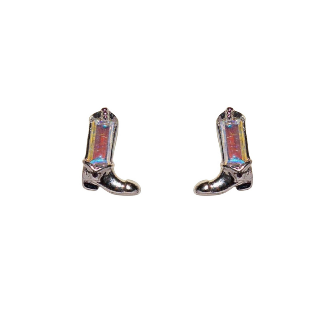 A pair of iridescent silver cowboy boot-shaped statement earrings with small star details, displayed on a white background.