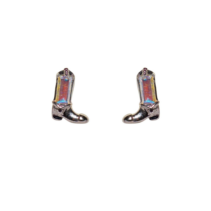 A pair of iridescent silver cowboy boot-shaped statement earrings with small star details, displayed on a white background.