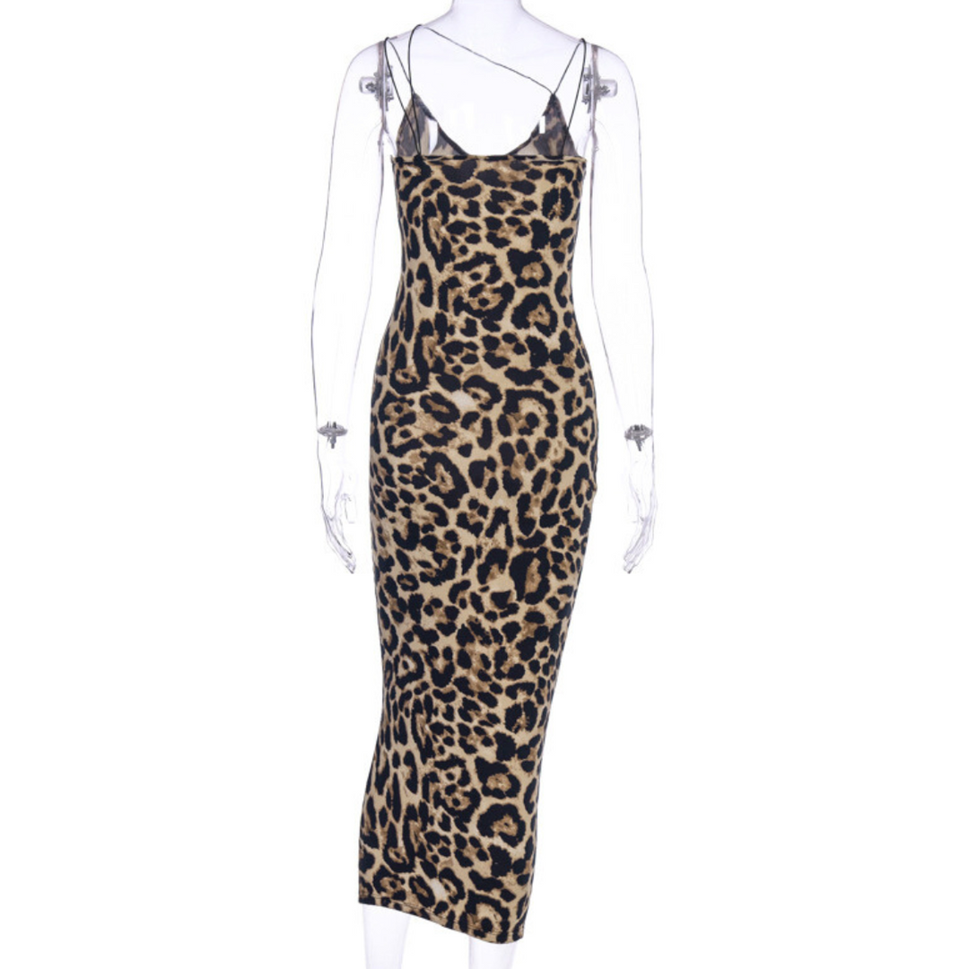 A sleeveless, form-fitting, ankle-length animal print dress with a bold leopard pattern and black spaghetti straps is displayed on a clear mannequin.