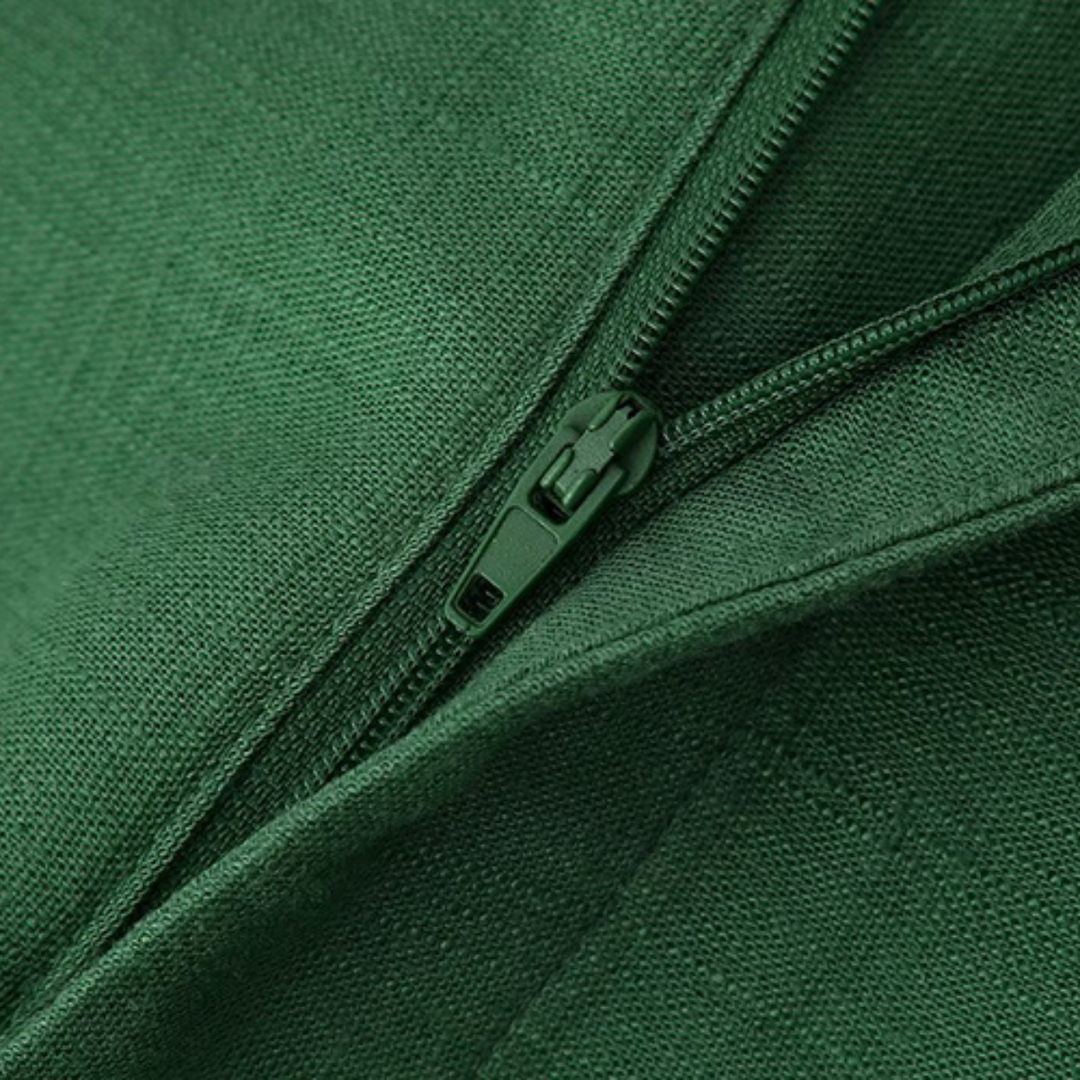 Close-up of a green zipper partially unzipped on green fabric, capturing the texture and details—perfect for adding flair to wide-leg trousers or boho chic pants.