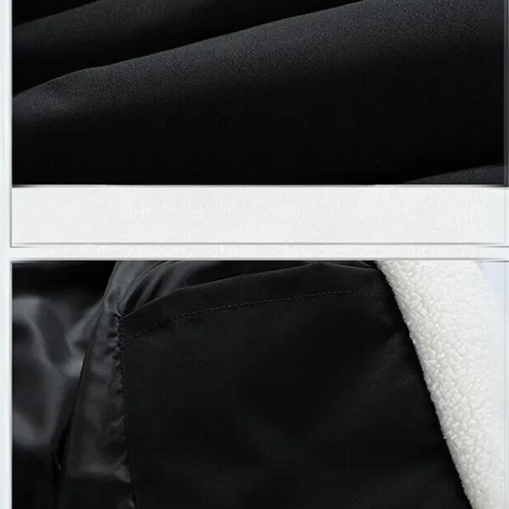 Close-up of a black fabric jacket featuring a contrast white fleece-lined interior visible along the edge and interior pocket area.