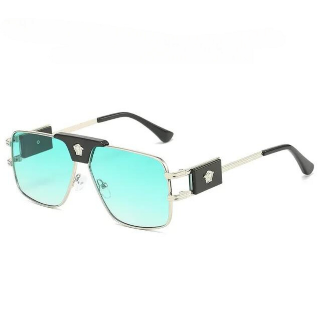 A pair of bold sunglasses with square, blue-green gradient lenses, thin premium metal frames, and black accents on the bridge and temples. The temples feature a small, silver emblem, while the lenses offer UV400 protection.