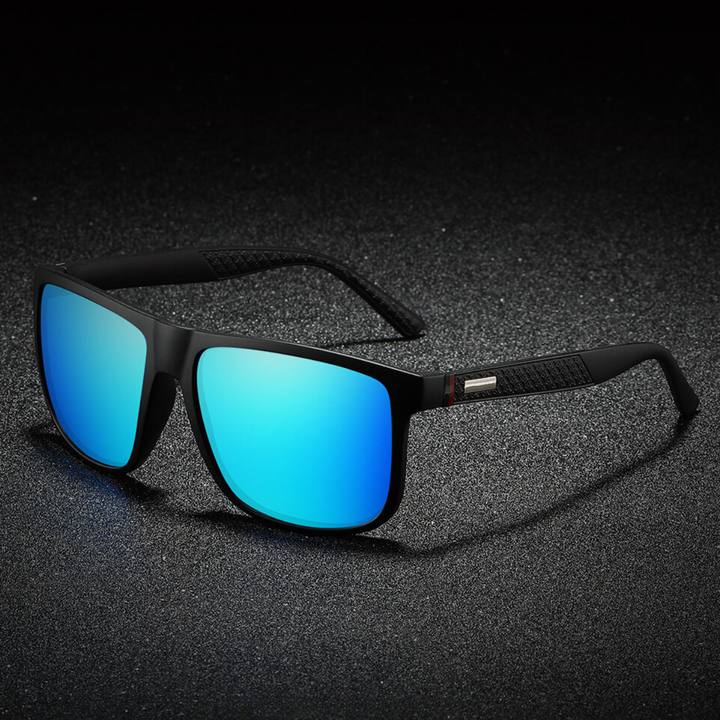 A pair of stylish sunglasses with large, rectangular blue mirrored lenses rests on a textured dark surface under dramatic lighting, blending bold design with modern appeal.