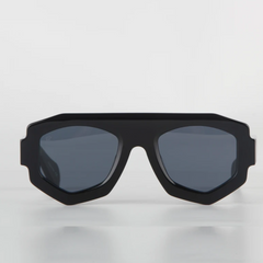 A pair of black geometric sunglasses with dark tinted lenses features a bold, angular acetate frame and offers UV400 protection, displayed against a plain white background.