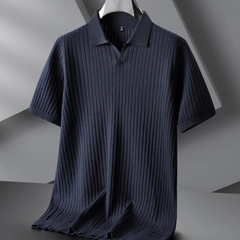 A dark navy blue ribbed knit polo with short sleeves and a vertical stripe texture hangs on a black hanger against a modern, geometric gray background—perfect for the urban professional.