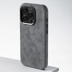 A phone case with four cameras, featuring a protective design and a luxurious suede finish.