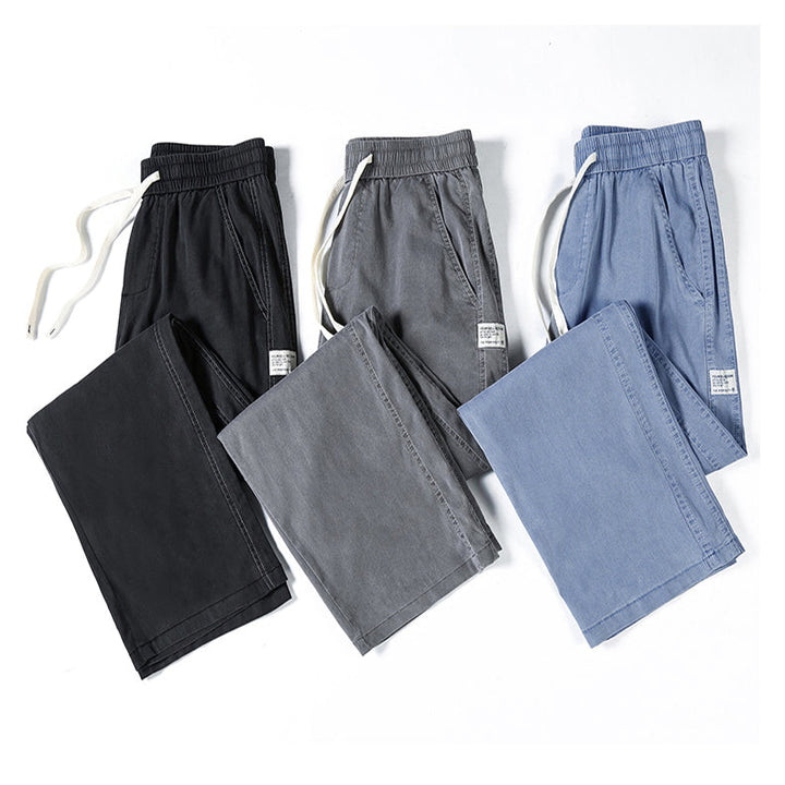 Three pairs of summer loose men jeans in black, gray, and light blue are laid out flat with matching folded pairs beside each, all displayed on a white background.