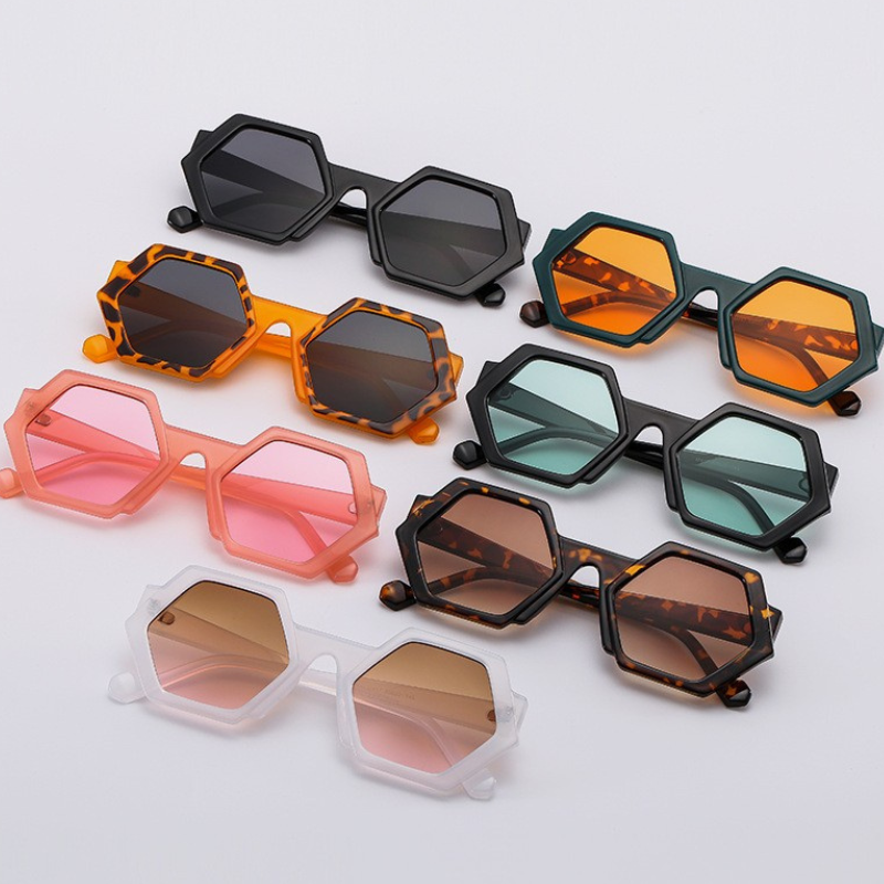 Eight pairs of trend-forward hexagonal frame sunglasses in various colors—black, orange, green, pink, tortoiseshell, and white—are arranged neatly on a white background. All feature UV400 protection for stylish sun safety.