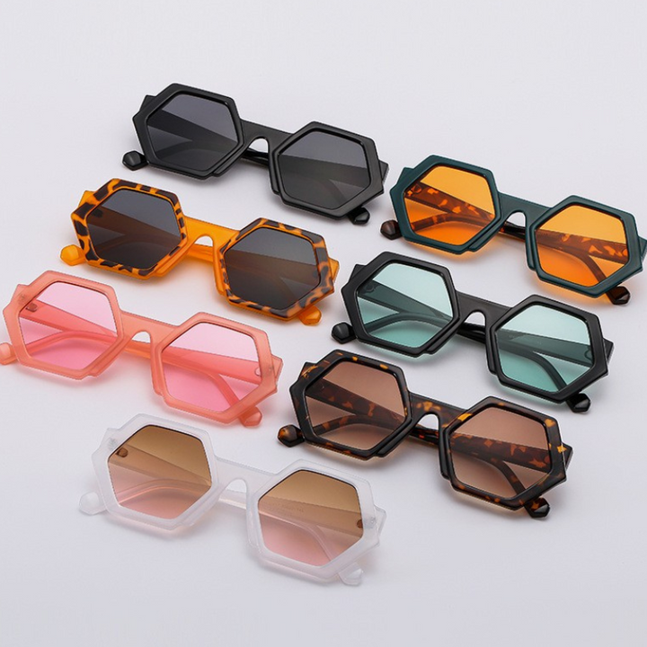 Eight pairs of trend-forward hexagonal frame sunglasses in various colors—black, orange, green, pink, tortoiseshell, and white—are arranged neatly on a white background. All feature UV400 protection for stylish sun safety.