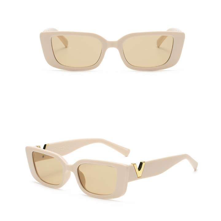 A pair of beige, designer sunglasses with geometric frames and tan lenses shown from the front and at an angle; gold V details are visible on the arms near the hinges.