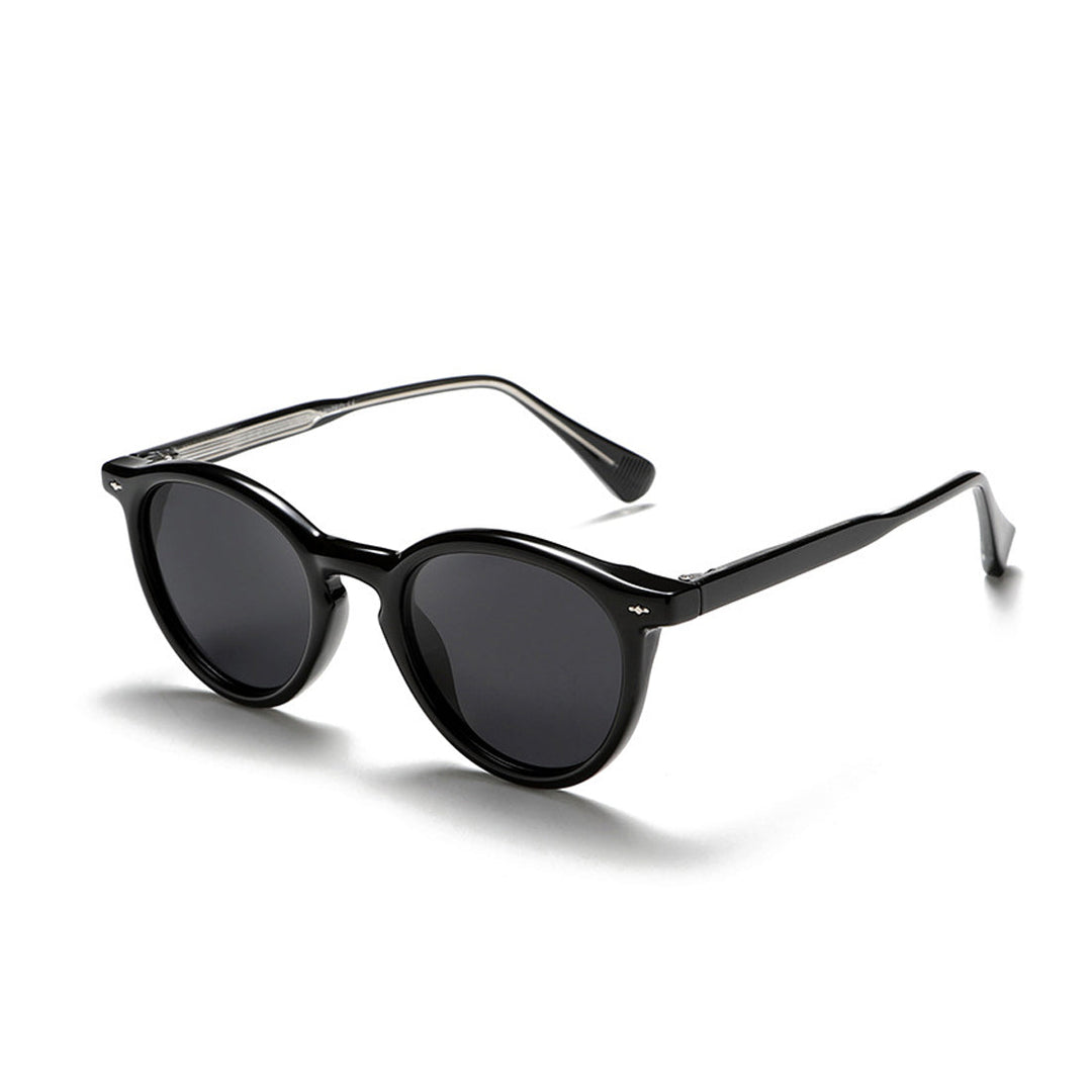 Black round frame sunglasses with dark lenses and thick glossy frames, shown at an angle on a white background—perfect as fashionable eyewear for a bold statement look.