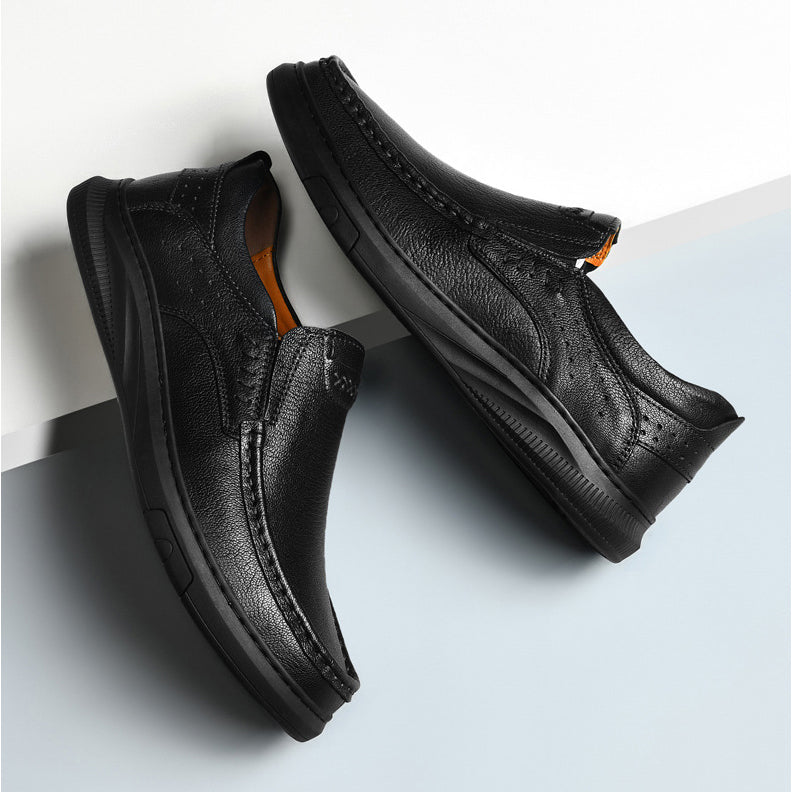 A pair of men's cowhide leather slip-on shoes with textured uppers and thick soft soles, positioned diagonally on a white and light blue background.