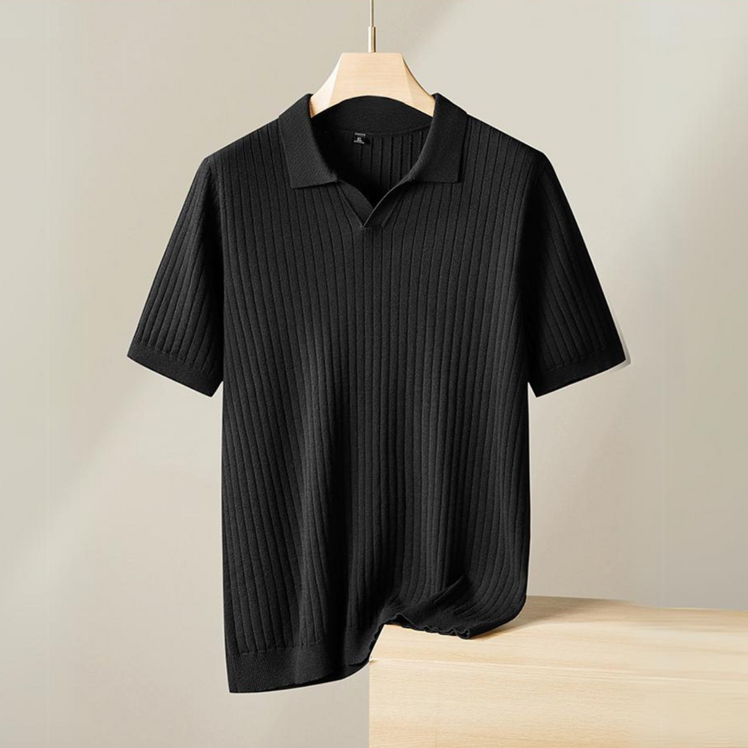 A short-sleeved, black ribbed knit polo shirt with a subtle vertical pattern is displayed on a wooden hanger against a neutral background—perfect for the urban professional seeking effortless style.
