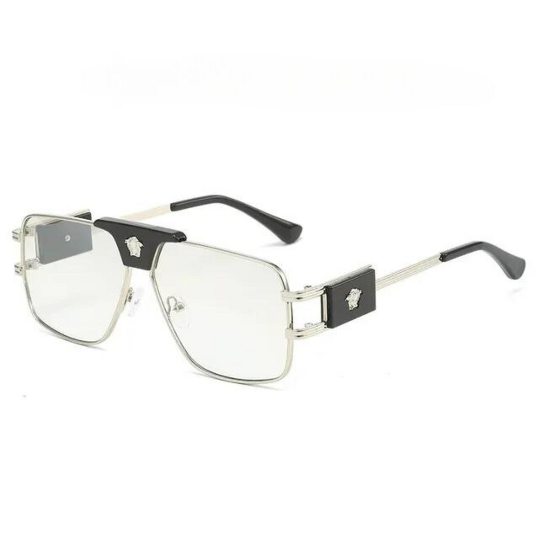 Silver metal eyeglasses with rectangular clear lenses, premium metal frames, black accents on the corners, and decorative emblems on the temples. The arms are thin and silver with black tips.