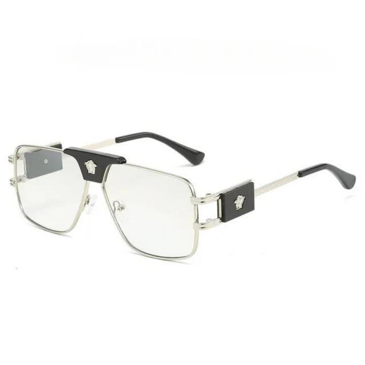 Silver metal eyeglasses with rectangular clear lenses, premium metal frames, black accents on the corners, and decorative emblems on the temples. The arms are thin and silver with black tips.