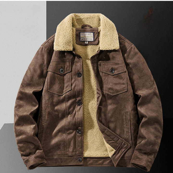 A brown suede jacket with a structured fit and Sherpa lining, featuring buttoned chest pockets and front closure, laid flat on a two-tone black and gray surface.