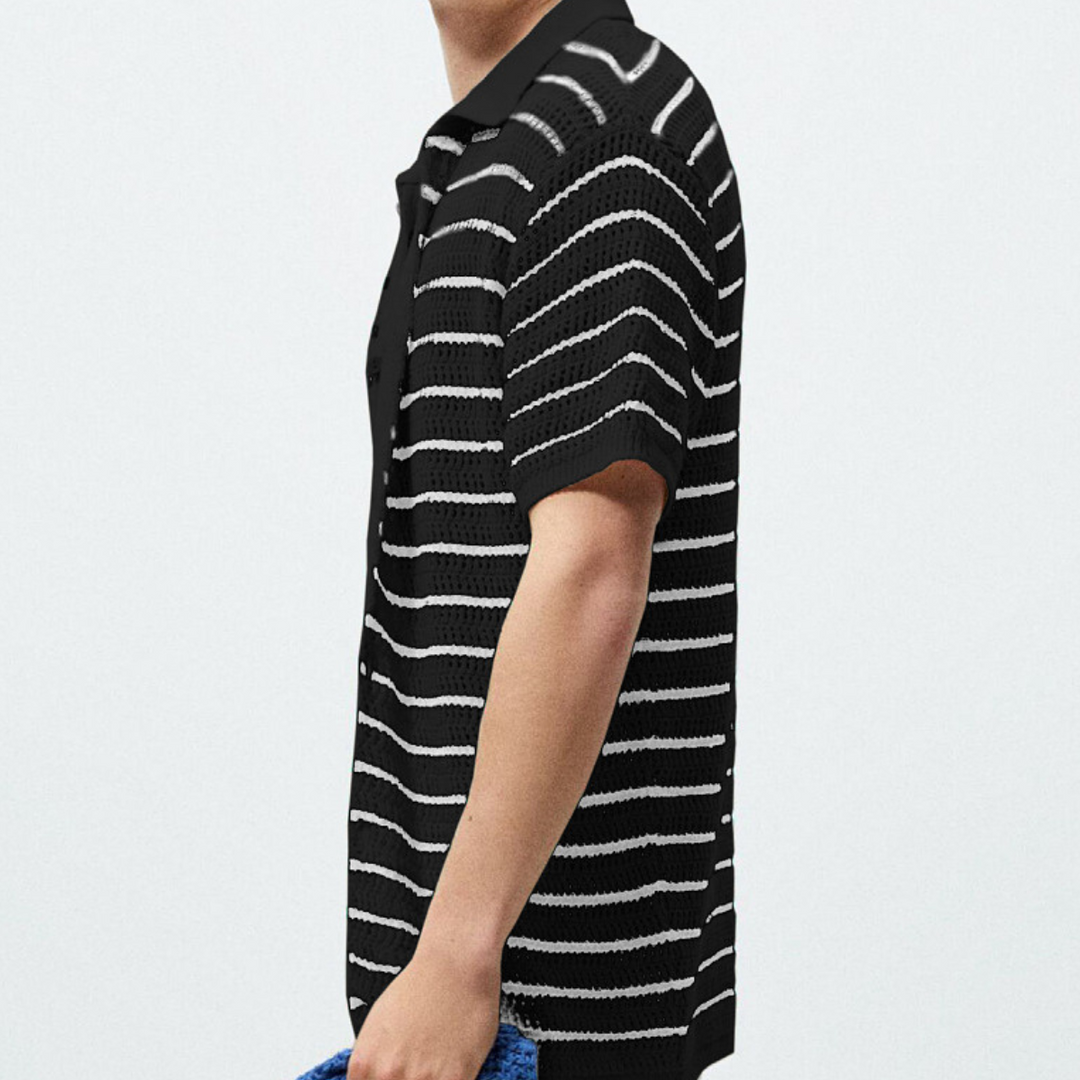 A person wearing a retro knit polo with horizontal white stripes, holding a blue textured item, is shown from the shoulders down against a plain light background.