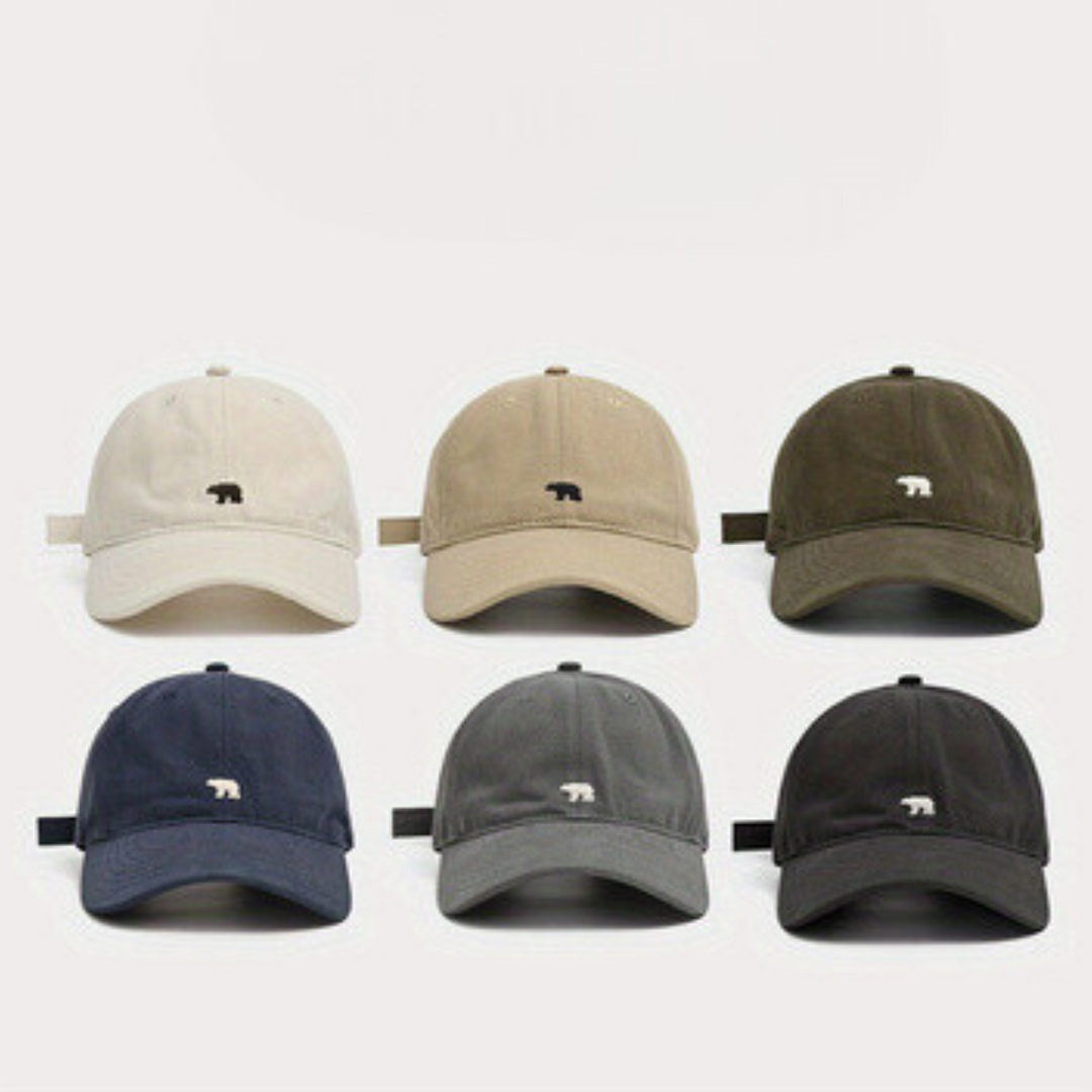 Six premium cotton baseball caps in beige, olive green, navy blue, light gray, dark gray, and black—each with a small bear logo—are arranged in two rows. Their wide brim design offers added sun protection on any outing.