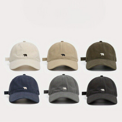 Six premium cotton baseball caps in beige, olive green, navy blue, light gray, dark gray, and black—each with a small bear logo—are arranged in two rows. Their wide brim design offers added sun protection on any outing.