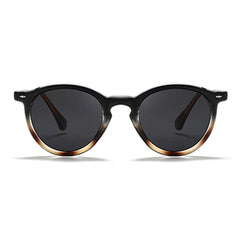 Fashionable eyewear, these round frame sunglasses feature black frames and dark lenses with a subtle gradient to a lighter brown at the bottom for a chic, modern look.